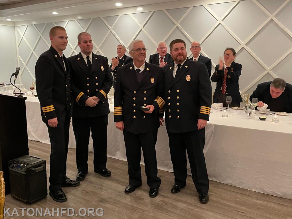 50 Year Member Ex Chief Paul Gallagher with (from left) First Assistant Chief Matt Whalen, Second Assistant Chief John Whalen, and Chief Mike Griffiths. Photo by Erich Braun.