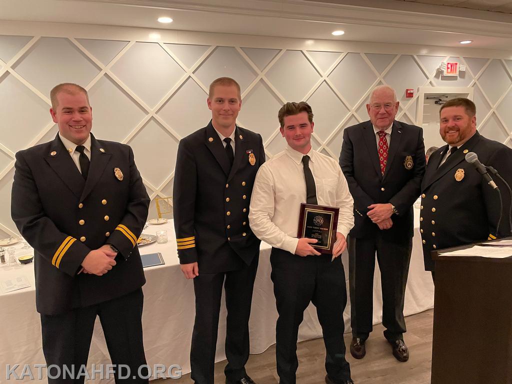 Second Assistant Chief John Whalen, First Assistant Chief Matt Whalen, Firefighter of the Year Nate Fischer, Board of Fire Commissioners Chairman Hank Bergson, and Chief Mike Griffiths. Photo by Erich Braun.