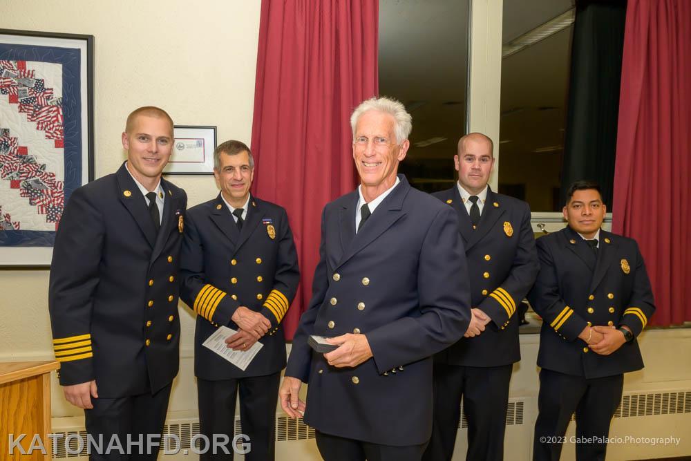 Firefighter Charlie Noe receives his 50-year badge. L-R, Chief Matt Whalen, President Dean Pappas, Charlie Noe, First Assistant Chief John Whalen, Second Assistant Chief John Cohen. Photo by Gabe Palacio.